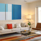 a living room filled with furniture and a painting on the wall