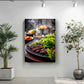 a close-up of a grill with various meats and vegetables, including what appears to be grilled chicken and lettuce. The grill is surrounded by a potted plant on the left and a plant on the right, creating a cozy and inviting atmosphere.