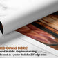 The image is a rolled canvas fabric, which is a type of canvas material used for creating posters or wall art. It is described as a tube-delivered fabric, which means it is delivered in a tube and requires stretching before use. It can be used as a poster with a 2.5" edge area.