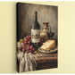 a still life arrangement featuring a bottle of wine, a glass of red wine, a plate of cheese, and a bunch of grapes.