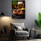 a cozy living room with a comfortable gray armchair, a wooden side table, and a potted plant. Above the armchair, there is a framed photograph of a pretzel with a beer mug and mustard on a plate.