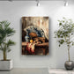 a still life painting of a table with a vase, fan, and fruit, including an orange and a pear, set against a white wall. The painting is hung on the wall, and there are two potted plants in the foreground, one on the left and one on the right.