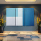 a blue and white room with two vases of flowers