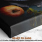 The image is a close-up of a black canvas print featuring a vibrant red apple and a green plant, with a text overlay that reads "READY TO HANG" and provides the dimensions of the print as "-1.5 inches" and "wrapped over a wooden frame."