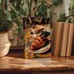 A framed photograph of a croissant and coffee is displayed on a wooden surface, surrounded by potted plants and books.