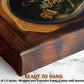 a wooden bowl filled with a green soup, placed on a wooden surface.