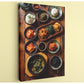 A wooden table is set with a variety of Asian dishes, including rice, vegetables, and sauces, arranged in an appealing manner.