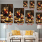 The image is a collage of six framed paintings depicting a table with various food items, including olives, a pitcher of wine, and a plate of fruit. The paintings are arranged in a grid format, with each painting having a different size and dimensions. The paintings are displayed on a wall above a white couch, creating a cozy and inviting atmosphere in the living room.