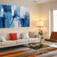 a living room filled with furniture and a painting on the wall