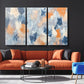 a living room filled with furniture and a painting on the wall
