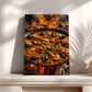 A framed photograph of a paella dish with seafood, including shrimp, mussels, and clams, cooking over a fire.